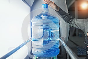 Plastic bottle with purified drinking water inside automated conveyor production line. Water factory