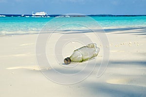 Plastic bottle on sand beach. Plastic pollution of nature. Ecology and environment concept. Waste emission to ocean