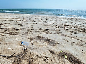 Plastic bottle on sand beach the pollution of environment contamination at seaside