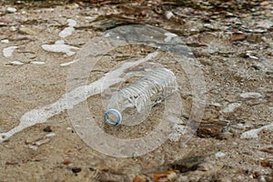 Plastic bottle on sandy beach pollution