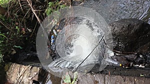 Plastic bottle waste blocks the flow of river water