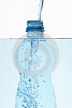 Plastic bottle in water with bubbles inside