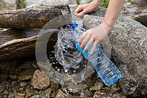 Plastic bottle water filling, natural pure water source.