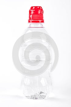 Plastic bottle of water with red cap.