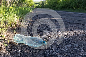 Plastic bottle with water by the road