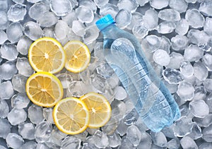 Plastic bottle of water with slice of lemon in ice photo