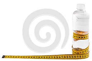 A plastic bottle with water wrapped in a yellow meter isolated on white background . Health concept. Bottled water for healthy