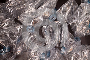 Plastic bottles background. Empty bottles on black surface photo