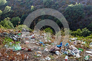 Plastic bottles, bags and other trash along road. Trash at roadside. Concept of environmental pollution