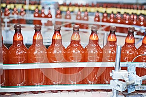 Plastic bottles with beer or carbonated beverage moving on conveyor