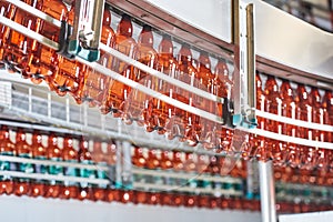 Plastic bottles for beer or carbonated beverage moving on conveyor