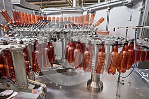 Plastic bottles for beer or carbonated beverage moving on conveyor