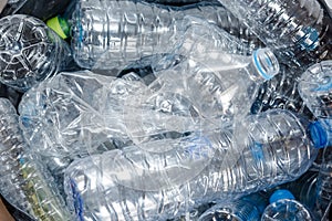 Plastic bottles in black garbage bags waiting to be taken to recycle.