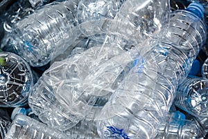 Plastic bottles in black garbage bags waiting to be taken to recycle