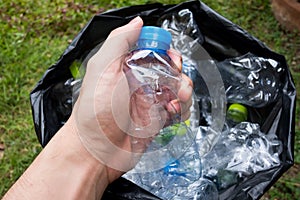Plastic bottles in black garbage bags waiting to be taken to recycle