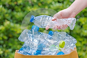 Plastic bottles in black garbage bags waiting to be taken to recycle