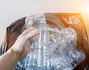 Plastic bottles in black garbage bags waiting to be taken to recycle.