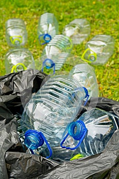 Plastic bottles in black plastic trash bag