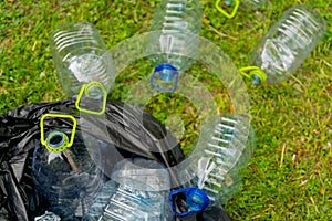 Plastic bottles in black plastic trash bag