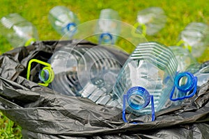 Plastic bottles in a black plastic trash bag