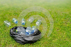 Plastic bottles in black plastic trash bag