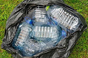 Plastic bottles in a black plastic trash bag