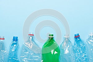 Plastic bottles on blue background top view. Recycle plastic waste pollution concept