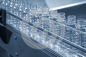 The plastic bottles on the conveyor belt at the drinking water factory.