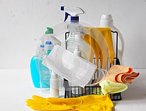 Plastic bottles with detergents and disinfectants on a light background for cleaning and disinfecting at home.Use of protective