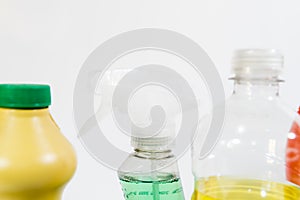 Plastic bottles with different cleaning liquids on the floor