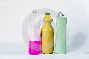 Plastic bottles with different cleaning liquids on the floor