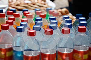 Plastic bottles with drinks and colorful lids