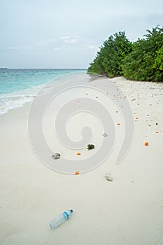 Plastic bottles and food waste at beach at tropical island