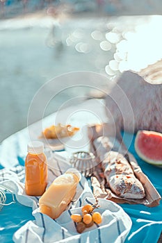 Plastic bottles of freshly squeezed juice on the pier on a sunny day. Food at a picnic on the sea