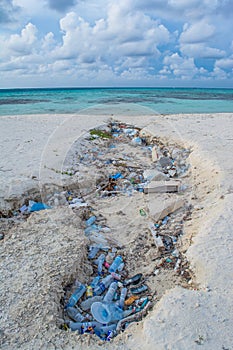 Plastic bottles and garbage at the tropical beach