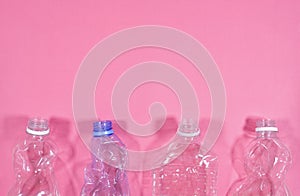 Plastic bottles isolated on pink background. Recycle waste management concept. Plastic Pet Bottles