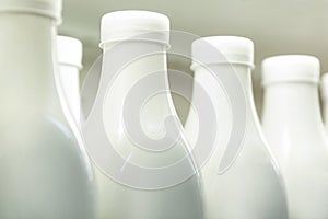 Plastic bottles with milk on the shelf in the store. Healthy eating. Close-up