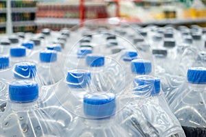 Plastic bottles in packs. Water bottles - plastic bottles factory warehouse store food background.