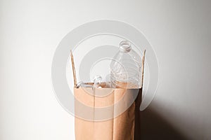 plastic bottles in paper bag for reuse concept.