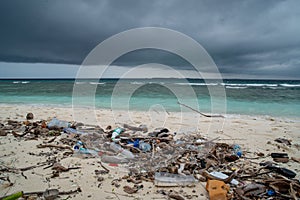 Plastic bottles, plastic bags and waste at dirty beach near ocean at the tropical island