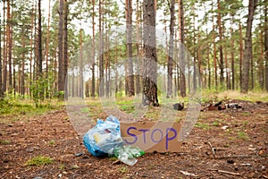Plastic bottles  in trash bags in forest background. Ecology concept