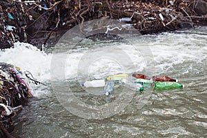 Plastic bottles and trash in the river water. Environmental pollution. Rubbish and waste. Plastic and trash pollution at nature