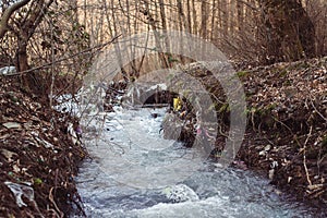 Plastic bottles and trash in the river water. Environmental pollution. Rubbish and waste. Plastic and trash pollution at nature