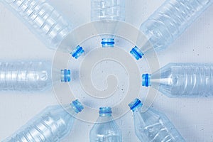 Plastic bottles on a white background as a symbol of ecological catastrophes.