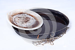 plastic bowl abandoned in a vase with stagnant water inside. close up view. mosquitoes in potential breeding ground