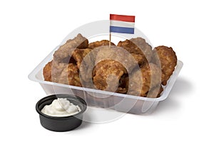 Plastic bowl with traditional Dutch kibbeling and sauce