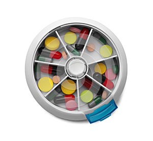 Plastic box with different pills on white, top view
