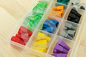Plastic box full of caps for rj 45 cable red, green and yellow