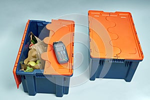 Plastic box with products. Food delivery in platinum boxes. Safe delivery. Storage of fragile goods.