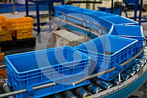 Plastic box on roller line for tranfer production part in prodine lin in factory